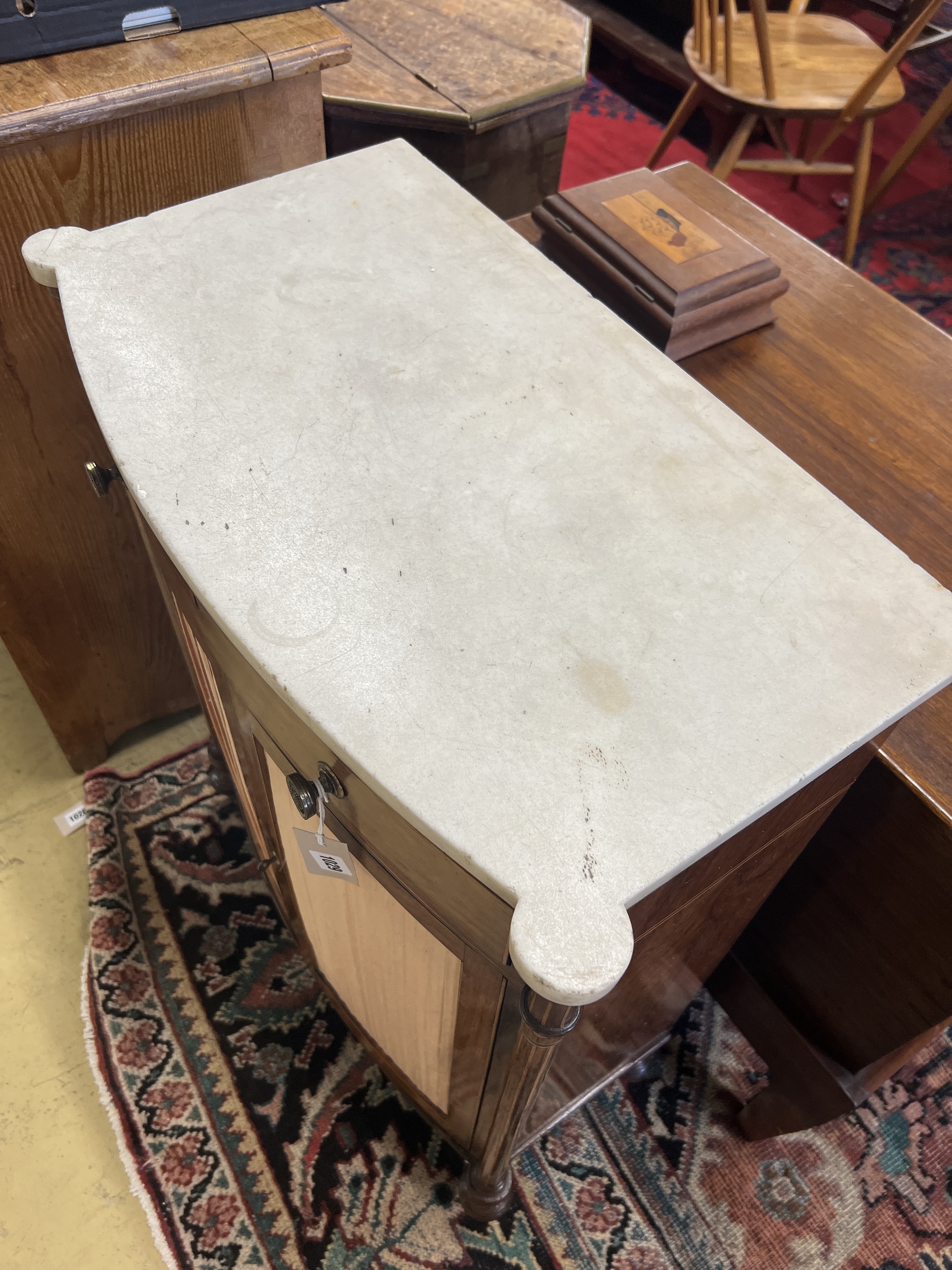 A George III Sheraton style faded rosewood bow front marble top side cabinet, width 65cm, depth 35cm, height 89cm